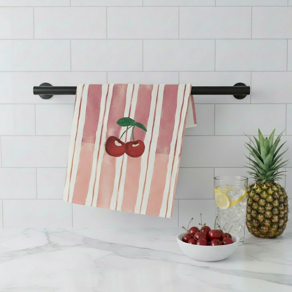 Striped towel with cherry design hanging on a kitchen wall