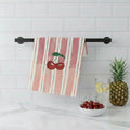 Striped towel with cherry design hanging on a kitchen wall