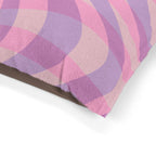 Close-up of a pink and purple checkered fabric with a white background